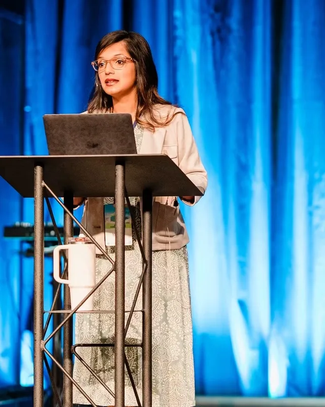 Dr. Nancy Thomas, PhD, speaking from a conference stage